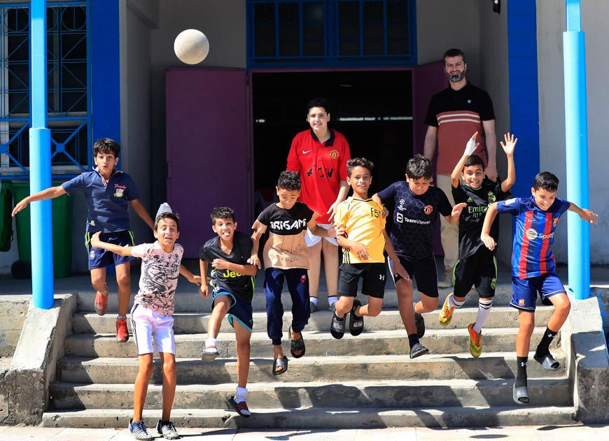 Palestinian boys jump during a soccer training session at a school (Палестинские мальчики прыгают во время футбольной тренировки в школе), 2023