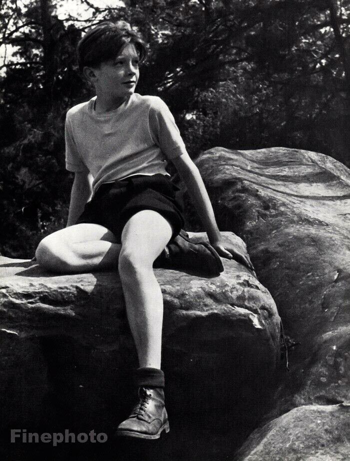 Boy hiking sitting on rocks outdoors (Мальчик в походе, сидящий на скалах), 1958