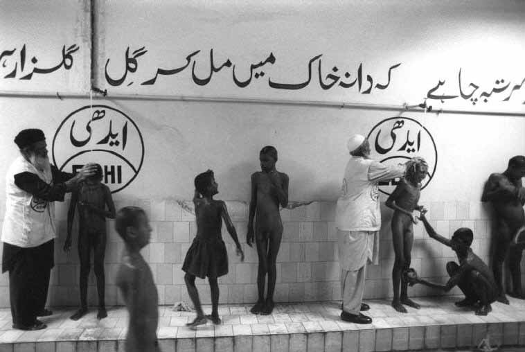 Every Sunday, the official Pakistan holiday, Abdul Sattar Edhi bathes mentally handicapped children at the Edhi village, 1997